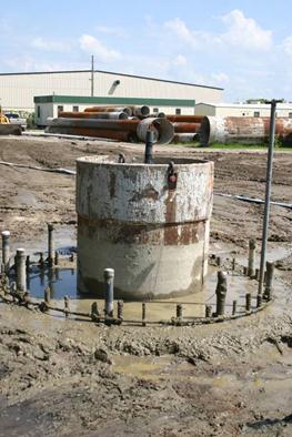 This photo shows the finished shaft with the access tubes and the reinforcing cage stickups surrounding the central casing. The centralized access tube can also be seen, as well as a mounting pole for the data collection system.