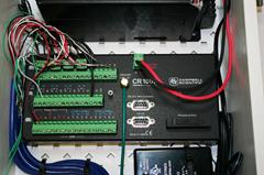 The figure shows the Campbell Scientific Inc. CR1000 data logger. It is relatively small (approximately 4 inches (101.6 mm) tall and 8 inches (203.2 mm) long) and has screw terminal connections for instruments, power in and out, and digital inputs and outputs. Communication between the data logger and the cellular modem was provided by the serial RS-232 port.