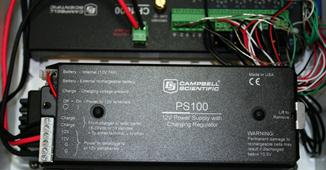 The figure shows the PS100 12-V power supply which came complete with a 7 amp-h rechargeable battery. It was capable of recharging the battery using alternating current or direct current sources typical of land power or solar panel. An external deep cell battery (not shown) was also maintained by the PS100 through screw terminals dedicated for that application.