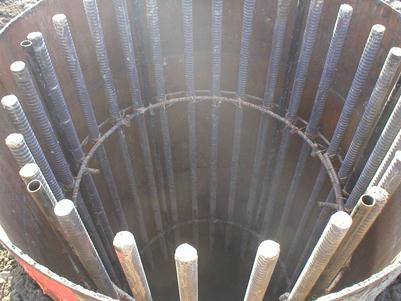 The photo shows the top section of the drilled shaft. The shaft reinforcing cages use 20 main bars and incorporate 6 access tubes for subsequent cross-hole sonic logging. Permanent casing is also used.