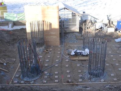 This photo shows four shafts. Conduits were placed on the ground at the base of the footing location prior to concreting that protected the instrumentation wiring running from shafts to data acquisition system (DAS) boxes located on the nearby covered fence. Note that only shaft 1 (left) and shaft 2 (right) were instrumented. Spacer blocks are shown on which the lowest level of footing reinforcement was to be placed. The main reinforcing bars from the shafts were left uncut to extend into the footing.