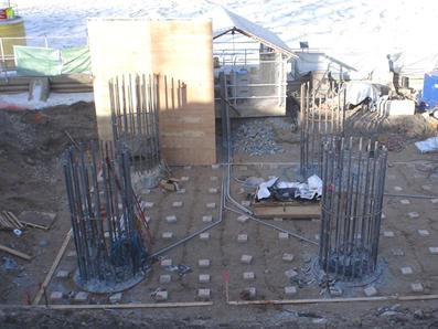 This photo shows four shafts. Conduits were placed on the ground at the base of the footing location prior to concreting that protected the instrumentation wiring running from shafts to data acquisition system (DAS) boxes located on the nearby covered fence. Note that only shaft 1 (left) and shaft 2 (right) were instrumented. Spacer blocks are shown on which the lowest level of footing reinforcement was to be placed. The main reinforcing bars from the shafts were left uncut to extend into the footing.