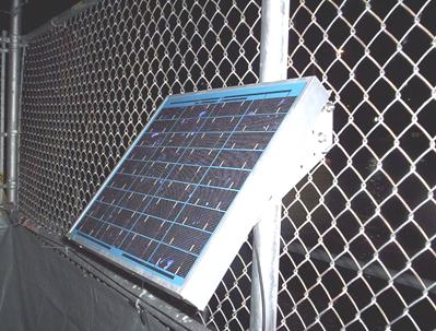This photo shows a large 35-W solar cell panel used for this project. The panel was positioned along the edge of the construction site on the adjacent fence line to avoid interference with construction.