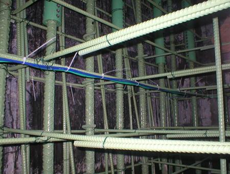 This photo shows gauge wires tied and secured inside a column. The lead wires from each set of corner gauges were carefully routed around the perimeter of the reinforcing cage to a prescribed exit point where a conduit was previously positioned.