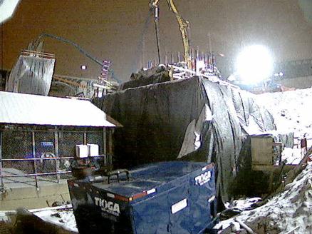 This photo shows lift 1 column concrete placement upon completion of the footing concreting and sufficient curing. This formwork as well as the reinforcing steel can be seen above the plastic-wrapped footing.