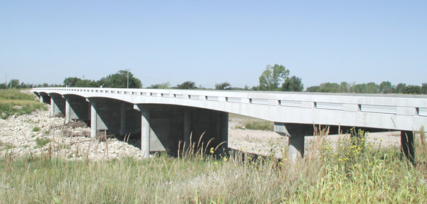 Figure 11. Photo. CIP PT concrete slab bridge. This photo shows a completed cast-in-place (CIP) post-tensioned (PT) concrete slab bridge