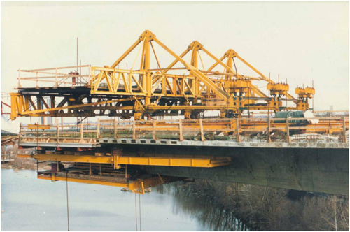 Figure 14. Photo. CIP balanced cantilever bridge during constructing using form traveler. This photo shows a cast-in-place (CIP) balanced cantilever bridge using form traveler under construction over a body of water