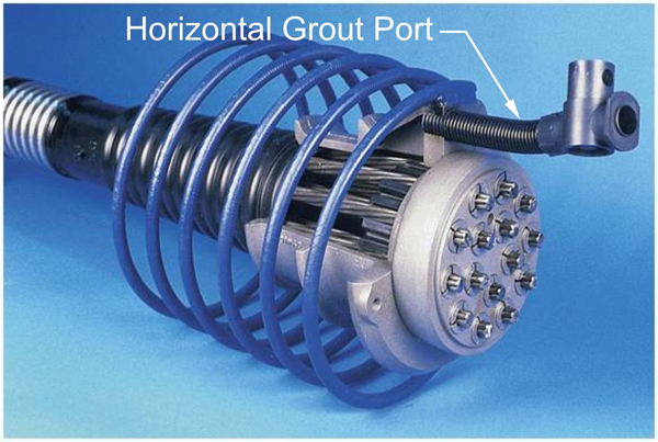 Figure 2. Photo. Old generation of PT anchorage system. This photo shows an old generation post-tensioned (PT) anchorage system with only the horizontal grout port identified