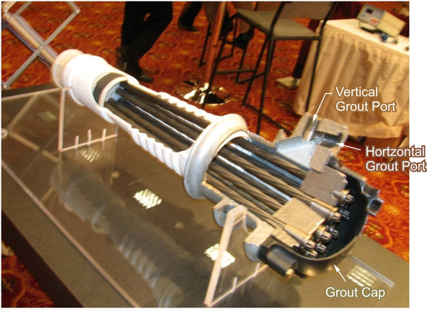 Figure 3. Photo. New generation of PT anchorage system. This photo shows a sectioned new generation post-tensioned (PT) anchorage system with the vertical grout port, horizontal grout port, and grout cap