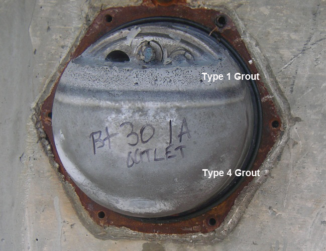 Figure 33. Photo. Opened anchorage on the Carbon Plant Road bridge over IH-37. This photo shows an opened anchorage on the Carbon Plant Road bridge over IH-37 showing an air void near the top followed by a layer of type 4 grout and type 1 grout beneath