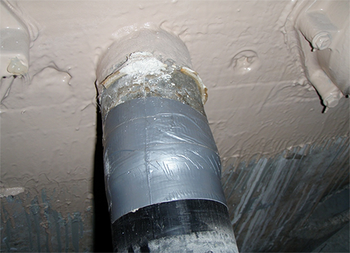 Figure 73. Photo. Temporary restoration of an external tendon. This photo shows an external tendon for which the duct had been locally removed for inspection and then temporarily repaired using waterproof tape. 