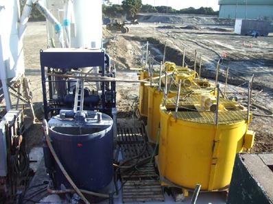 This photo shows a slurry batch plant and plant components, including a water tank and storage tanks.