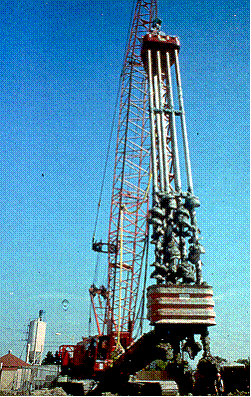 This photo shows a typical wet rotary shaft (WRS) mixing machine. Four axis mixing shafts are shown with staggered auger flights.