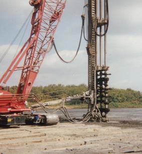 This photo shows another view of blade-based tooling for wet rotary shaft (WRS) mixing. The mixing shaft with paddles is shown partially in the ground.