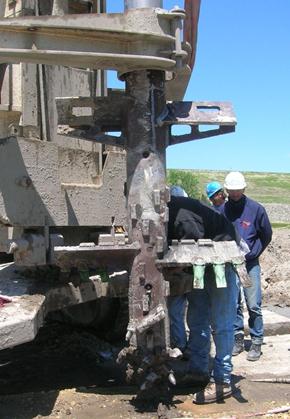 This photo shows typical equipment for wet rotary end (WRE) mixing. The mixing tool is being inspected by site workers.