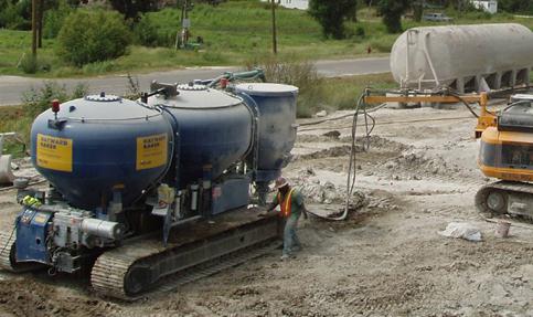 This photo shows a typical binder delivery unit for dry mixing. A binder storage/premixing and supply unit and silos with binders are shown in addition to other equipment.