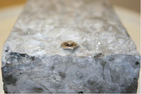 The image shows the embedment depth and bonding of the cast screw attachment to the concrete for Sample 3. When compared with figure 39 and figure 40, this image shows inconsistencies in embedment depth and bonding of the cast screw attachment.