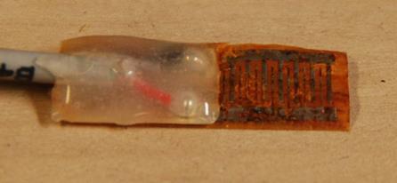 This photo shows a corroded linear polarization resistance (LPR) sensor after 1 week of testing. Both electrodes of one LPR sensor are badly corroded. 