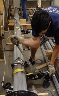 This photo shows a person compacting a strand bundle using a come-along tool.