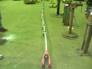 This photo shows a final straight strand from the coiled wire stretched out on the ground. 