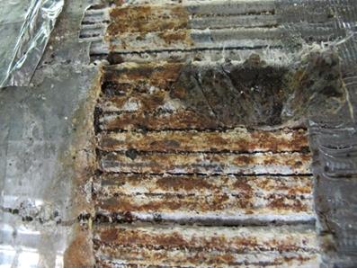 This photo shows wires under the cable band showing signs of stage 3 corrosion. A 2-by-2-inch (50.8-by-50.8-mm) area on the top of the south end of the cable displays a large amount of ferrous corrosion. 