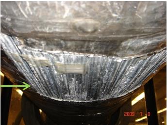 This photo shows a close-up view of one of the 11.89-by-11.89-inch (30.5-by-30.5-cm) holes placed in the aluminum cable cover. The individual wires of the bottom of the cable mockup are shown. Salt deposit and stage 1 zinc corrosion product can be seen on the wires.