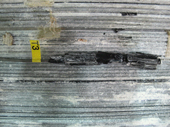 This photo shows Precon HS2000V sensor 3 as found during cable disassembly located between the bottom corner of one hexagonal strand and the top corner of another. 