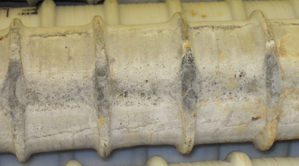 Figure 224. Photo. Defective grout along a bleed channel. This photo shows segregated grout along the bleed channel.