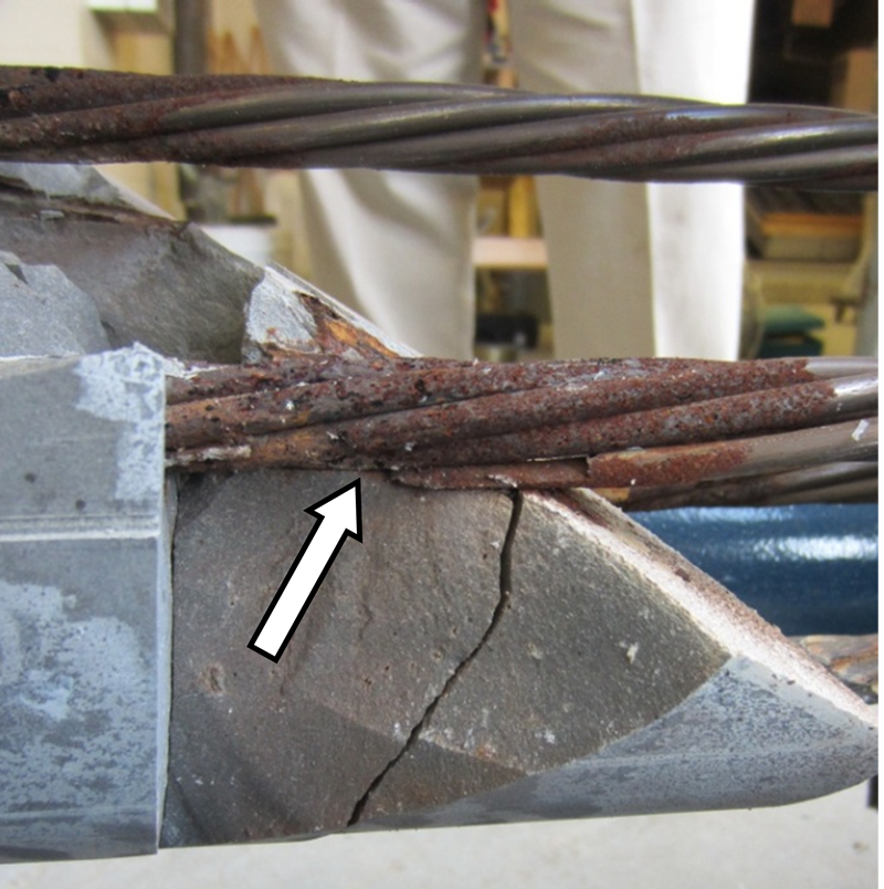 Figure 228. Photo. Close-up view of severely corroded strand with one broken wire revealed at the void/grout interface of 2.0 percent chloride multi-strand specimen. This photo shows a close-up view of a severely corroded strand with one broken wire at the void/grout interface of a 2.0 percent chloride multi-strand specimen.