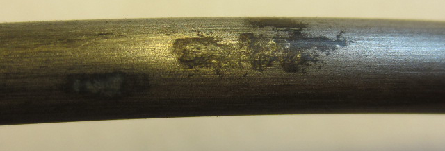 Figure 237. Photo. Stressed and voided 0.4 percent chloride single-strand specimen (pit depth < 2 mil). This photo shows minor pitting corrosion (pit depth was less than 2 mil) observed on a stressed 0.4 percent chloride single-strand specimen with void. 