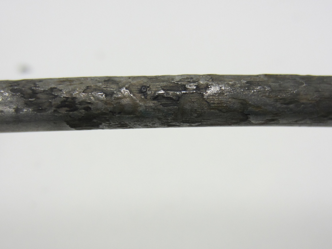 Figure 240. Photo. 0 percent chloride multi-strand specimen at the void/grout interface (pit depth = 2–4 mil). This photo shows moderate pitting corrosion (pit depth ranged between 2 and 4 mil) observed on an interface strand of 0 percent chloride multi-strand specimen.