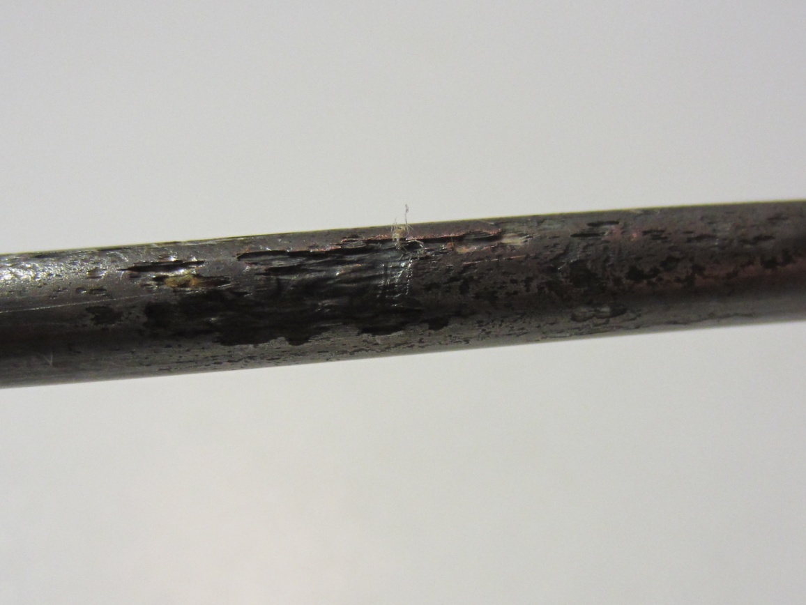 Figure 242. Photo. 0.6 percent chloride multi-strand specimen in the grout (pit depth = 2–14 mil). This photo shows moderate pitting corrosion (pit depth ranged between 2 and 
14 mil) observed on a strand fully embedded in 0.6 percent chloride multi-strand specimen.