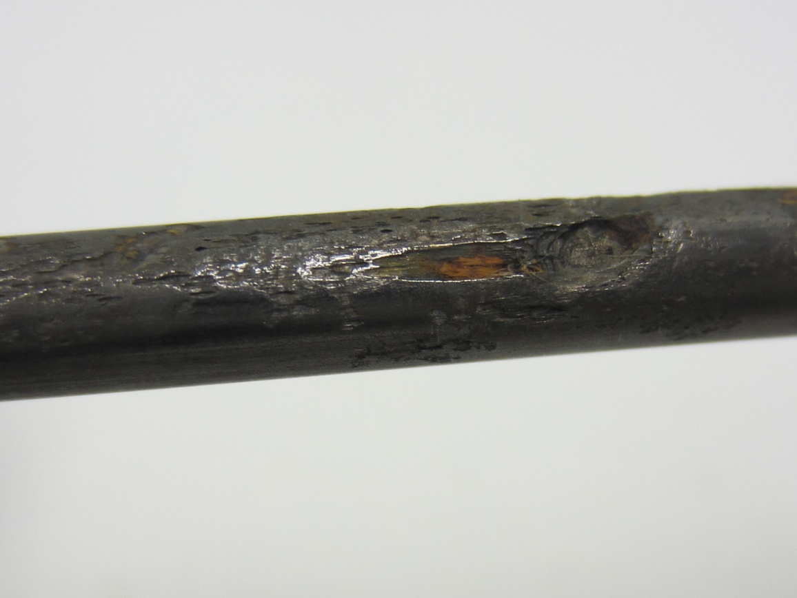 Figure 244. Photo. 1.0 percent chloride multi-strand specimen in the grout (pit depth = 2–23 mil). This photo shows severe pitting corrosion (pit depth ranged between 2 and 23 mil) observed on a strand fully embedded in 1.0 percent chloride multi-strand specimen.
