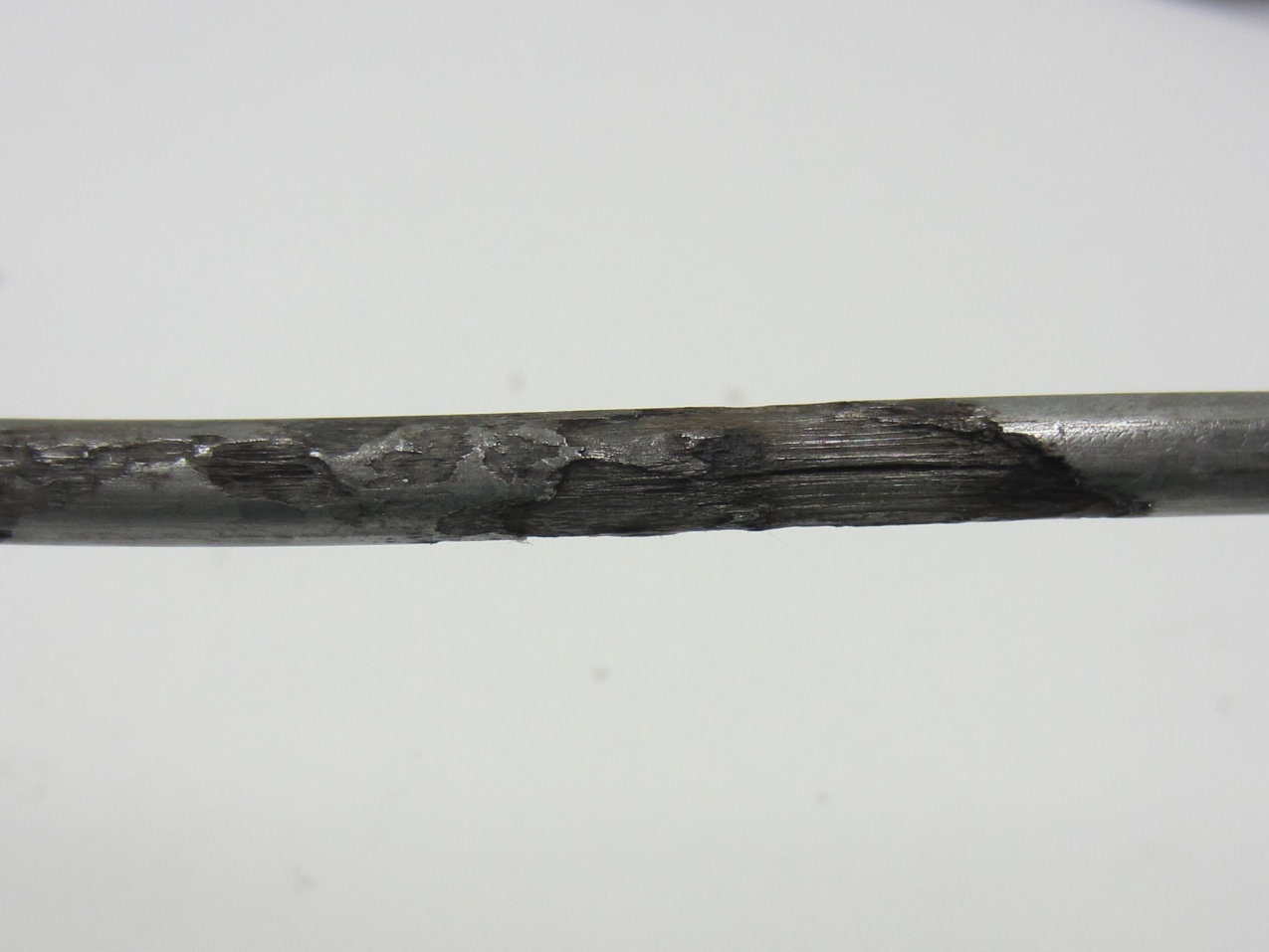 Figure 245. Photo. 0 percent chloride multi-strand specimen at the interface (pit depth = 2–36 mil). This photo shows severe pitting corrosion (pit depth ranged between 2 and 36 mil) observed on an interface strand of 0 percent chloride multi-strand specimen.