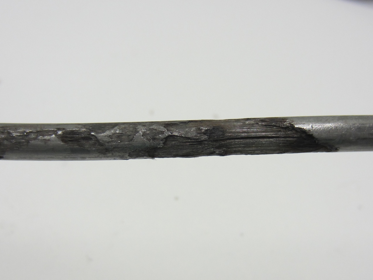 Figure 245. Photo. 0 percent chloride multi-strand specimen at the interface (pit depth = 2–36 mil). This photo shows severe pitting corrosion (pit depth ranged between 2 and 36 mil) observed on an interface strand of 0 percent chloride multi-strand specimen.