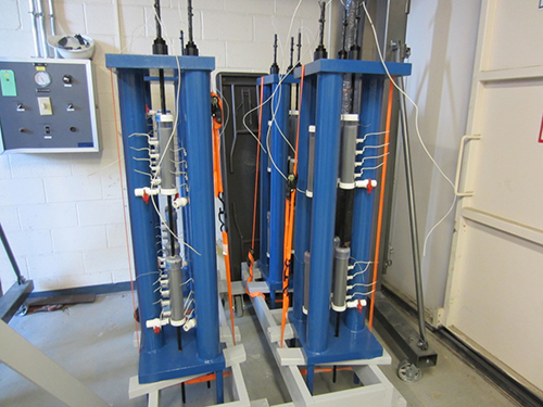 Figure 31. Photo. Fully assembled single-strand specimens. This photo shows fully assembled task 2.2 specimens prepared for grout installation in the laboratory.