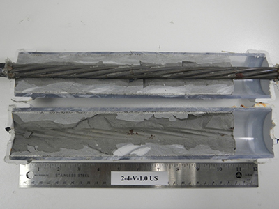 Figure 61. Photo. Single-strand specimen longitudinally cut in half. This photo shows two cut halves of the single-strand specimen shown in figure 60. 