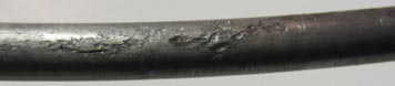 This photo shows representative pitting corrosion damage found on a 0.4 percent chloride concentration multi-strand specimen. It was determined that mean pit depth was 4.1 mil, and maximum pit depth was 9.0 mil.