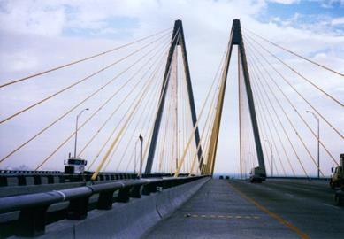 This photo shows the stay cable network that supports the Fred Hartman Bridge in Houston, TX. Taken from the bridge deck, it shows a series of cables rising up from the deck to towers in the distance.