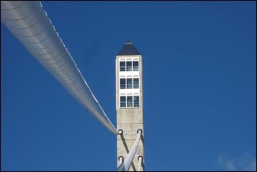 This photo shows the top of the west pylon. Above the cradle points of the highest cables are three rows of glass windows outlining the observation deck. This photo shows the top of the west pylon. Above the cradle points of the highest cables are three rows of glass windows outlining the observation deck.