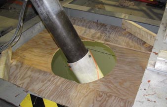 This photo shows the interface between the cable model and the roof of the wind tunnel. The unsealed hole allowing the cable to go through is larger than the cable.