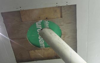 This photo shows the underside of the sealed interface between the cable model and the roof of the wind tunnel. The hole allowing the cable to go through is larger than the cable. 
