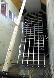 This photo shows the grid of ladders used to generate the turbulent flow field for position 1, which is 3.3 m upstream of the model. The grid consists of five ladders, each 6.4 m long, fixed side-by-side with an inclination the same as the cable model.