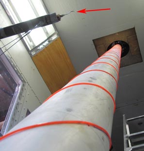 This photo shows the Turbulent Flow Instrumentation (TFI) Cobra Probe placed in the wake of the cable model directly behind ring 3 of pressure taps. The probe is mounted on the bracket independent from the cable model.