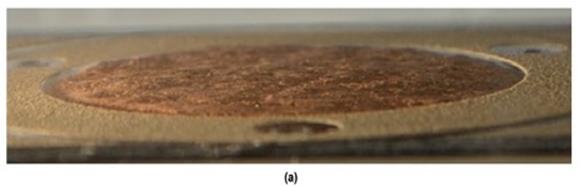 In this photo, a progression of erosion changes are seen. For the lower bed shear stress of 0.10 lbf/ft2 (4.9 Pa), there was no cloudiness (image a). The soil was eroded in small lumps over the soil surface. When the bed shear stress was increased to 0.21 lbf/ft2 (10 Pa), increasing cloudiness was observed, and larger lumps of soil were entrained in the flow (image b). When the bed shear stress was increased to 0.27 lbf/ft2 (13.1 Pa), the cloudiness increased, and the erosion rate increased. At this higher shear stress, shallow grooves appeared on the soil surface along the flow direction (image c).