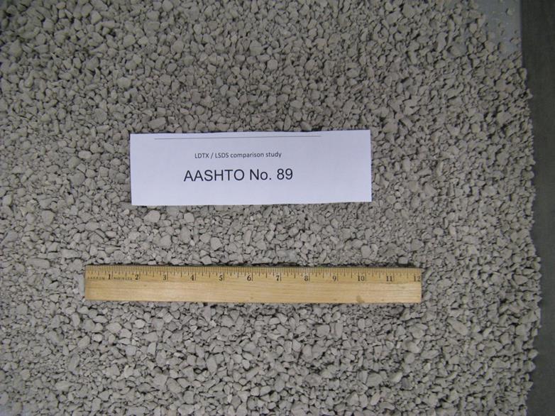 This photo shows the American Association of State and Highway Transportation Officials M43 gradation-based designated No. 89 aggregates with a limestone rock source from the Devonian period, supplied from a quarry in Defiance County, OH. The maximum values of dmax and d50, in inches, are 0.50 and 0.198, respectively. They are classified as a poorly graded gravel based on the Unified Soil Classification System. The minimum and maximum unit weights, in pounds per cubic ft, are 88.4 and 108.2, respectively.