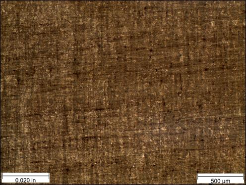 Figure 26. Photo. Micrograph near thread root etched with Marshall’s reagent at 50x magnification. This figure shows a micrograph near the thread root etched with Marshall’s reagent at 50x magnification. The micrograph was viewed under bright field illumination. A scale bar with a length of 0.020 inches is shown in the lower left corner of the photo, and a scale bar with a length of 500 micrometers is shown in the lower right corner. The sample is a mostly uniform brown color due to the etchant. 