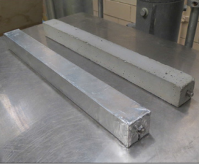 The photo shows the type of grout specimens used for measuring long-term autogenous (sealed) and drying shrinkage via ASTM C157.