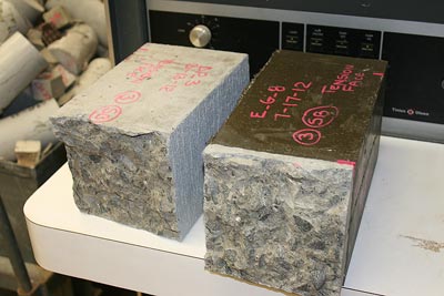 The photo shows complete concrete substrate failure from a bond flexural test using 6- by 6- by 21-inch (152.4- by 152.4- by 533.4-mm) prism specimens.