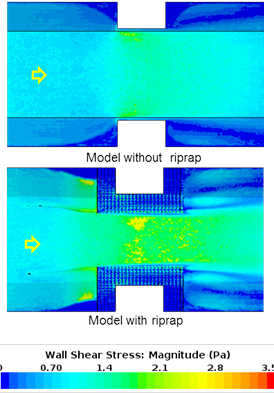 This figure compares plan views of bottom shear stress for a model without riprap (top) and with riprap (bottom) with less contraction than for case 11. In the case without riprap, shear stresses are slightly elevated near the upstream corners of the abutment. In the case with riprap, the shear stresses are moderately elevated in the center of the contracted section between the riprap layers. (1 lbf/ft2 = 47.88 Pa)